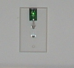 Closeup of Networked Robotics TPL3 temperature probe in RJ-45 jack of standard wall plate